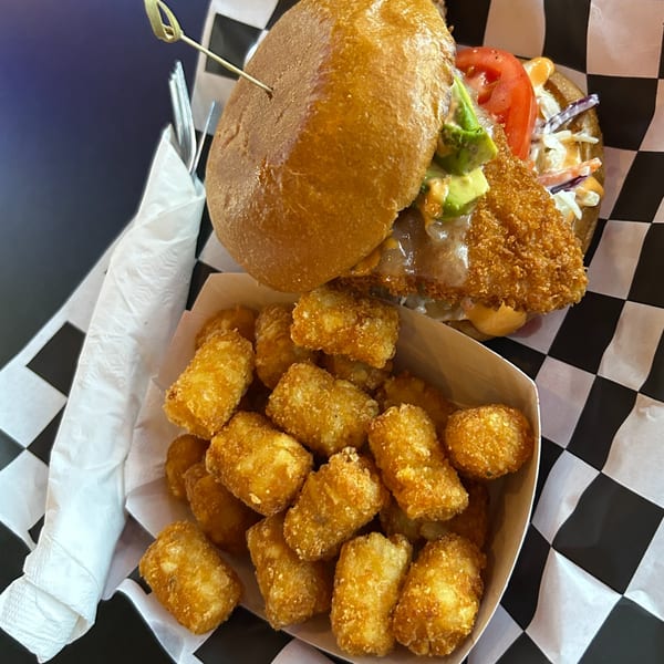 Moon Valley Grill & Patio's crispy chicken sandwich with avocado, tomato, and tater tots.